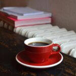 Cup of coffee near a heater supported by a heat pump system.